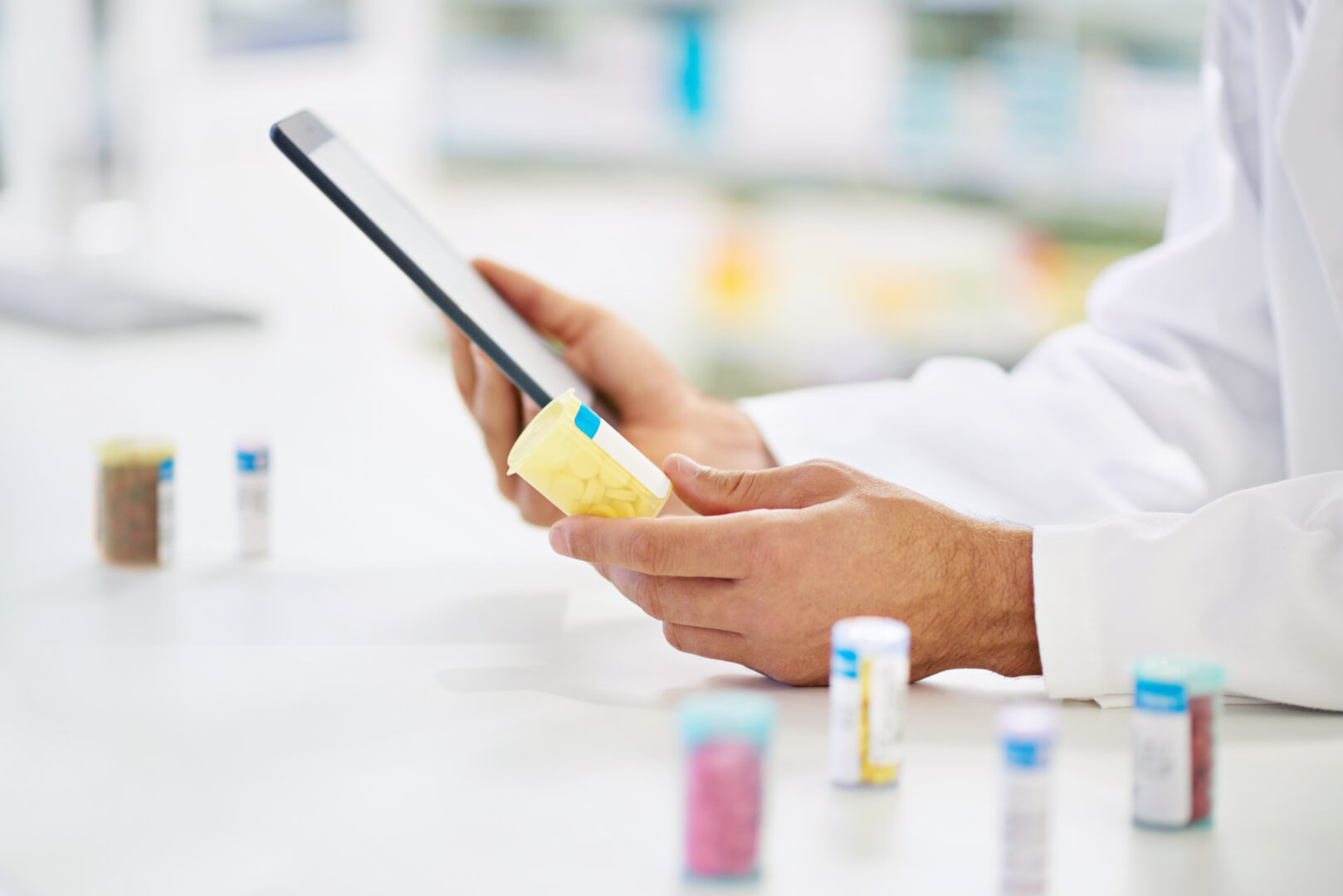 comparing-his-knowledge-a-pharmacist-working-on-a-digital-tablet