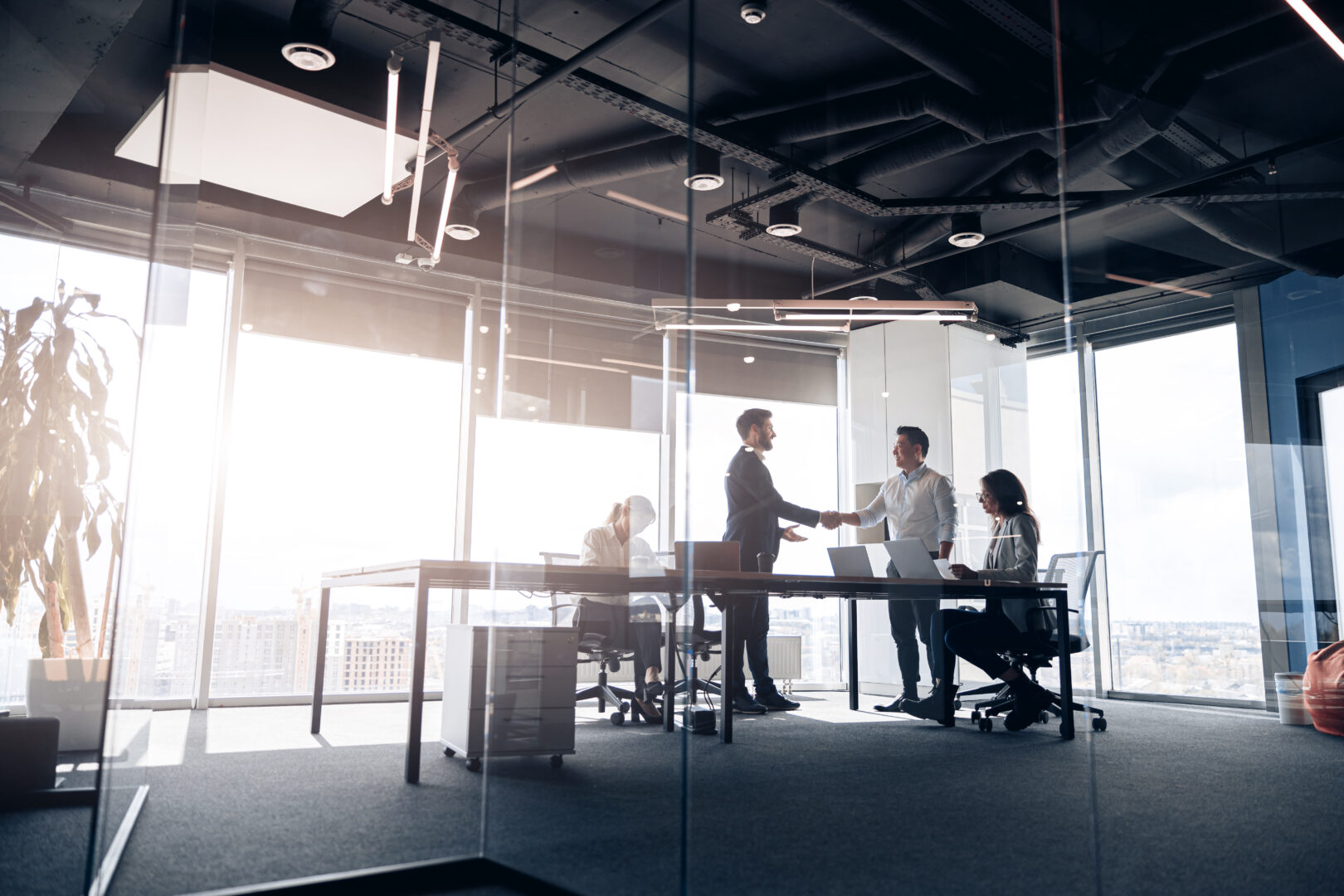 people-standing-near-table-team-of-young-businessmen-working-and-communicating-together-in-office
