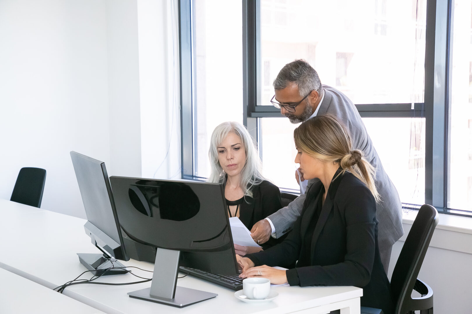 serious-business-group-of-three-analyzing-reports