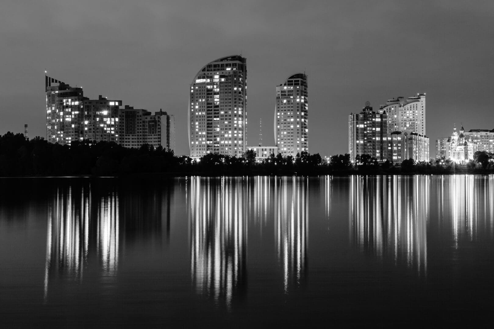 night-city-with-reflection-of-houses-in-the-river