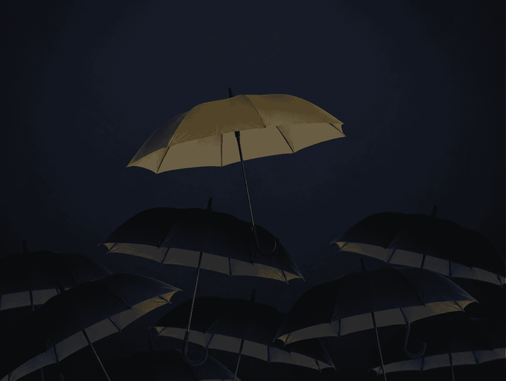 A single gold umbrella raised above a crowd of dark umbrellas, illustrating facultative reinsurance covering one exceptional risk outside a treaty
